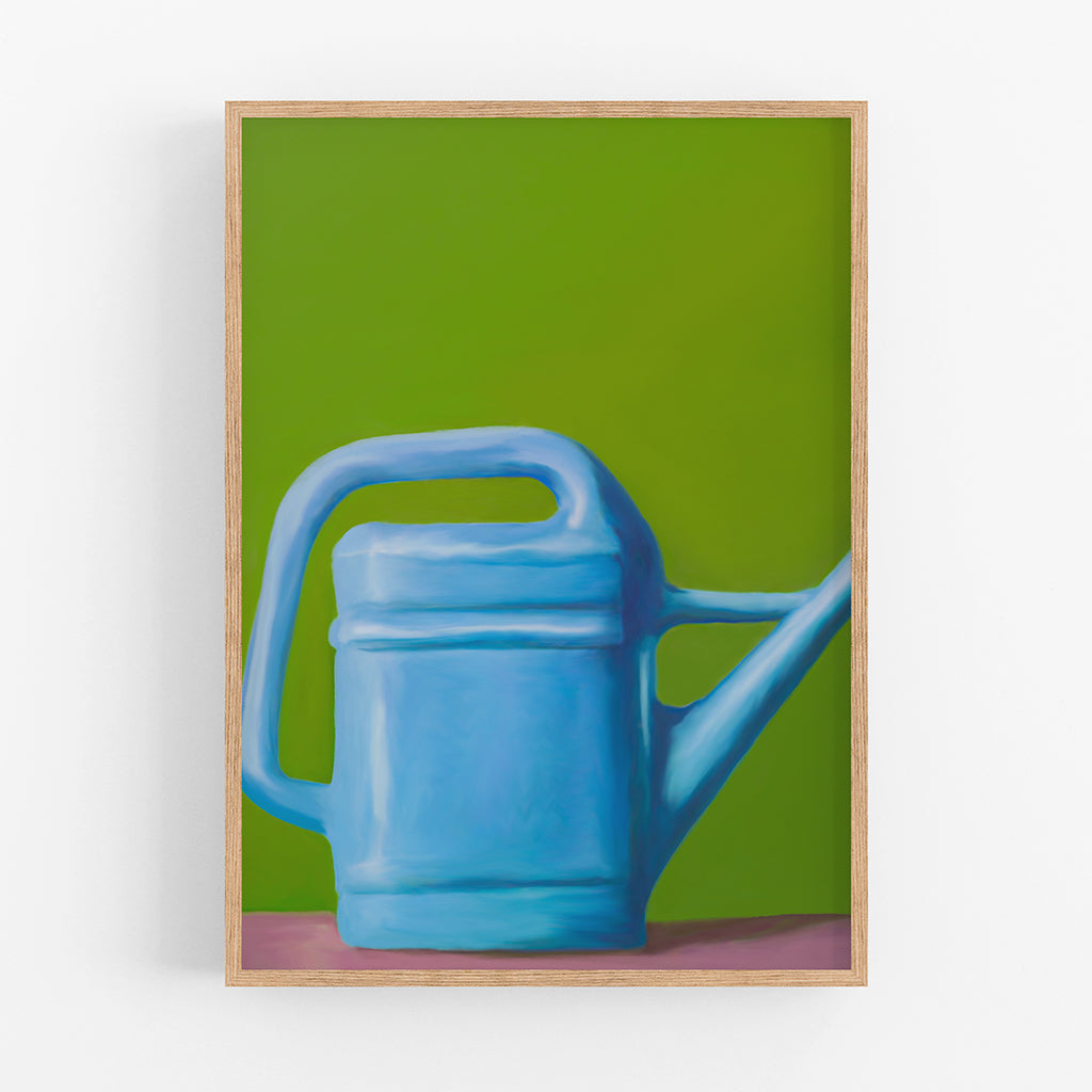 An art print of a blue watering can on a green background.